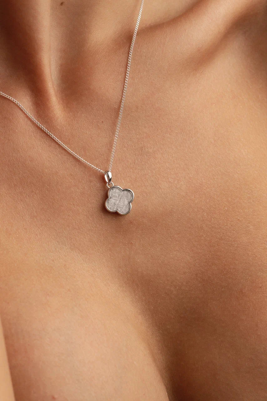 Handcrafted meteorite pendant with silver setting - authentic Muonionalusta meteorite, a celestial style with a genuine meteorite centerpiece. Explore the cosmos with this unique meteorite jewelry piece.