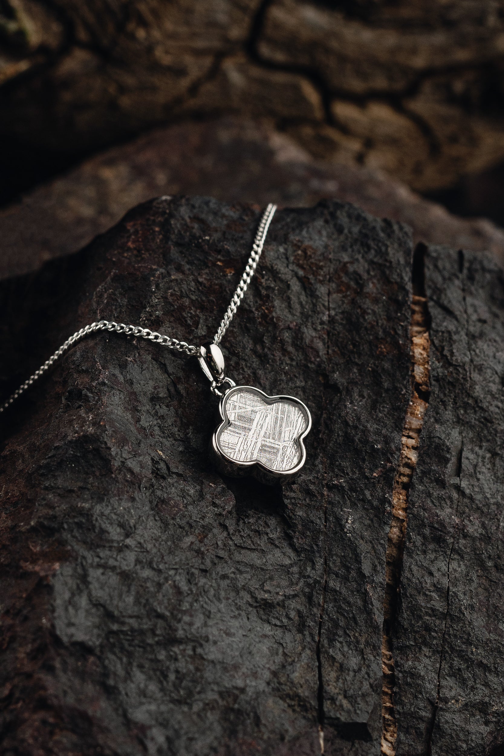 Handcrafted meteorite pendant with silver setting - authentic Muonionalusta meteorite, a celestial style with a genuine meteorite centerpiece. Explore the cosmos with this unique meteorite jewelry piece.